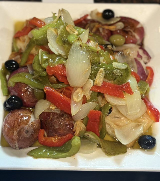 Bacalhau à Lagareiro with olive oil, garlic, roasted potatoes, peppers and onions