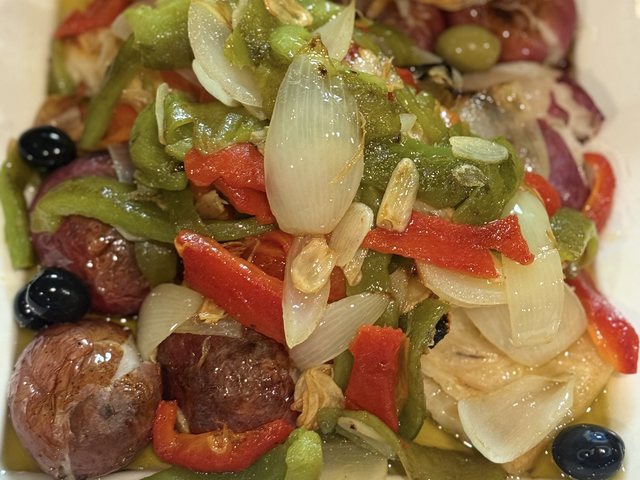 Bacalhau à Lagareiro with olive oil, garlic, roasted potatoes, peppers and onions