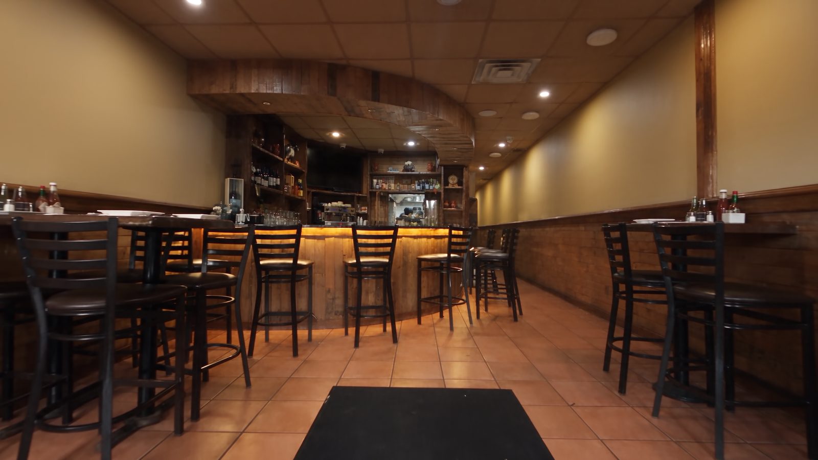 The warm wood-paneled dining room and bar at Churrasqueira Ribatejo