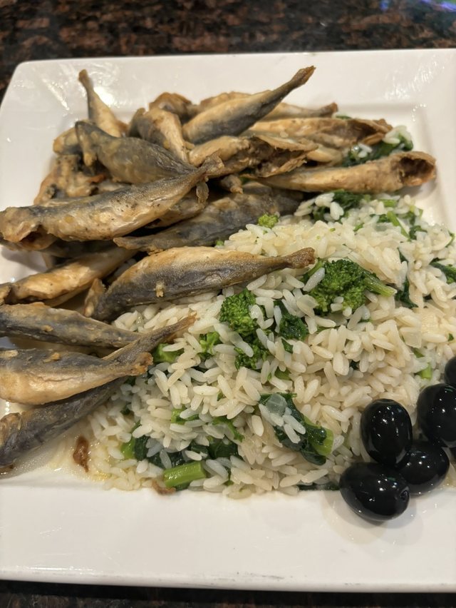 Fried small fish with rice & greens at Churrasqueira Ribatejo